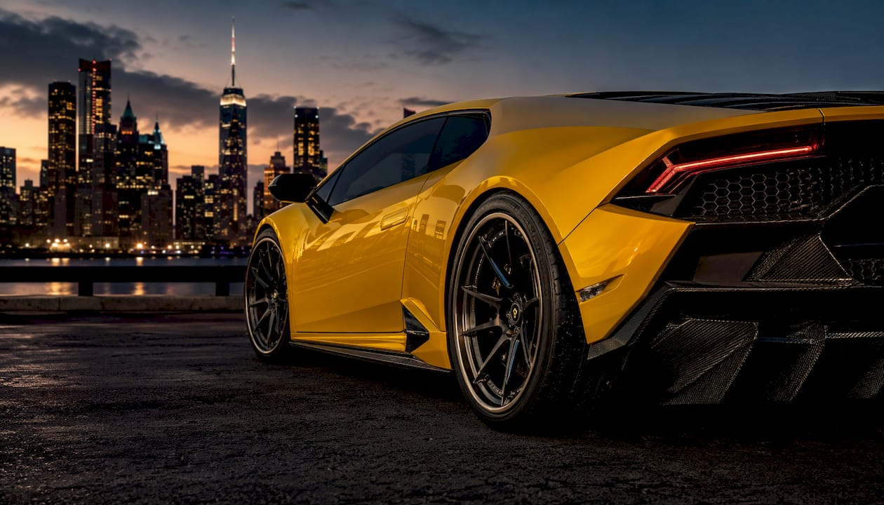 Close-up step lip wheel on McLaren 720S in dark studio