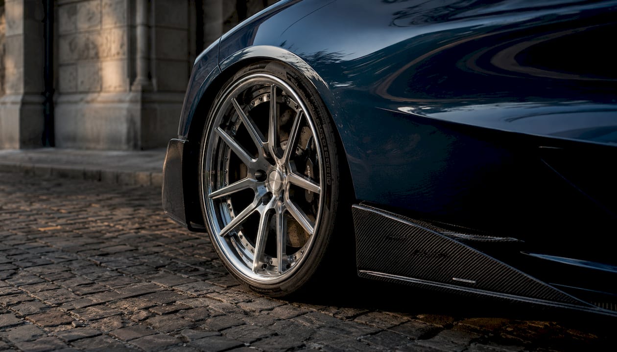 Close-up forged McLaren 720S wheel with carbon fiber diffuser