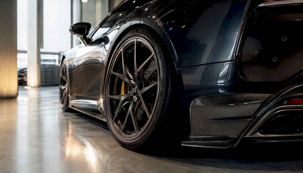 Close-up forged wheel and carbon fiber texture