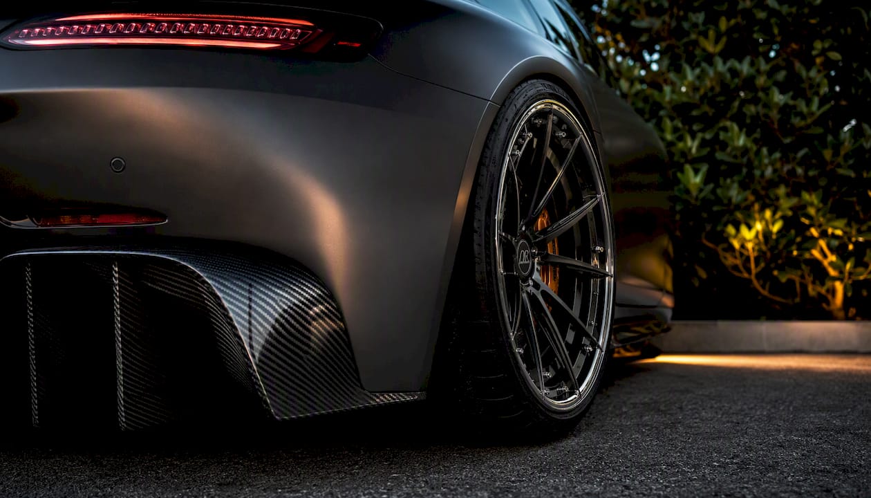 Close-up monoblock forged wheel on McLaren 720S in dark studio
