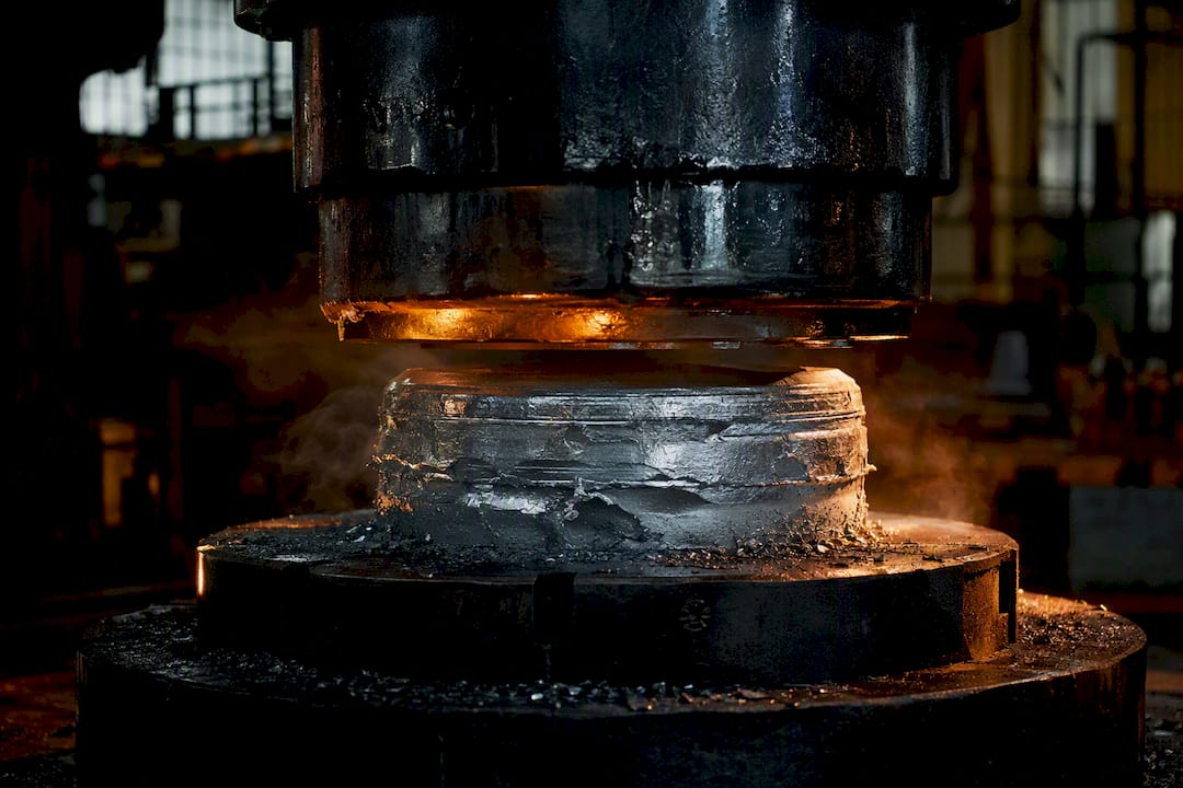 Close-up of forged aluminum wheel blank during forging