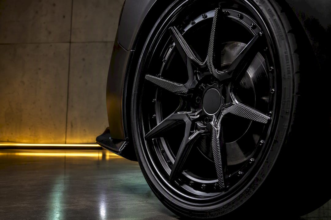 Two-piece forged wheel beside fender