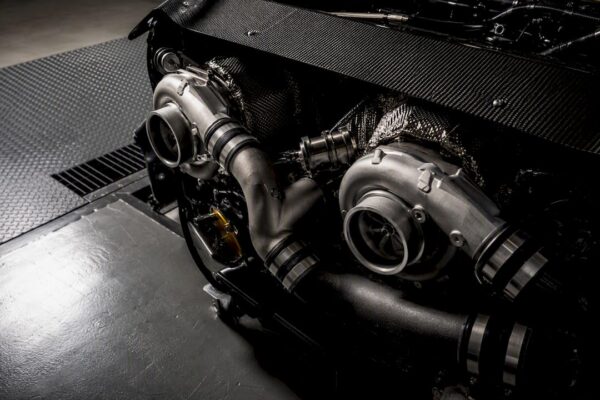 Twin turbo hardware in a dark engine bay