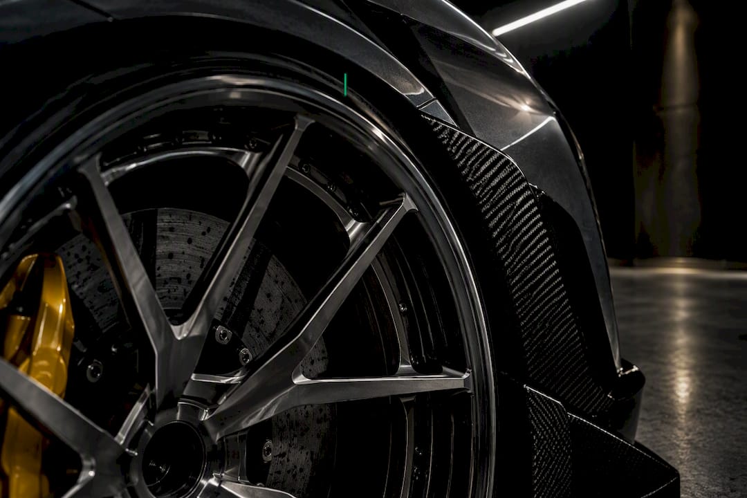 Forged wheel positioned beside brake caliper