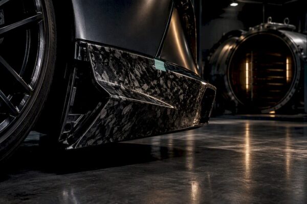 Forged carbon panel under dramatic workshop lighting