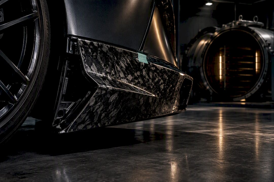 Forged carbon panel under dramatic workshop lighting
